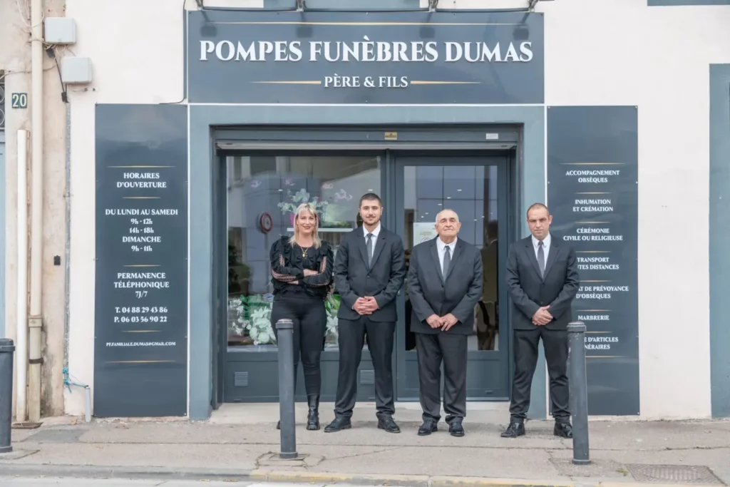 L'équipe de l'agence des Pompes Funèbres Dumas devant la vitrine du magasin.
